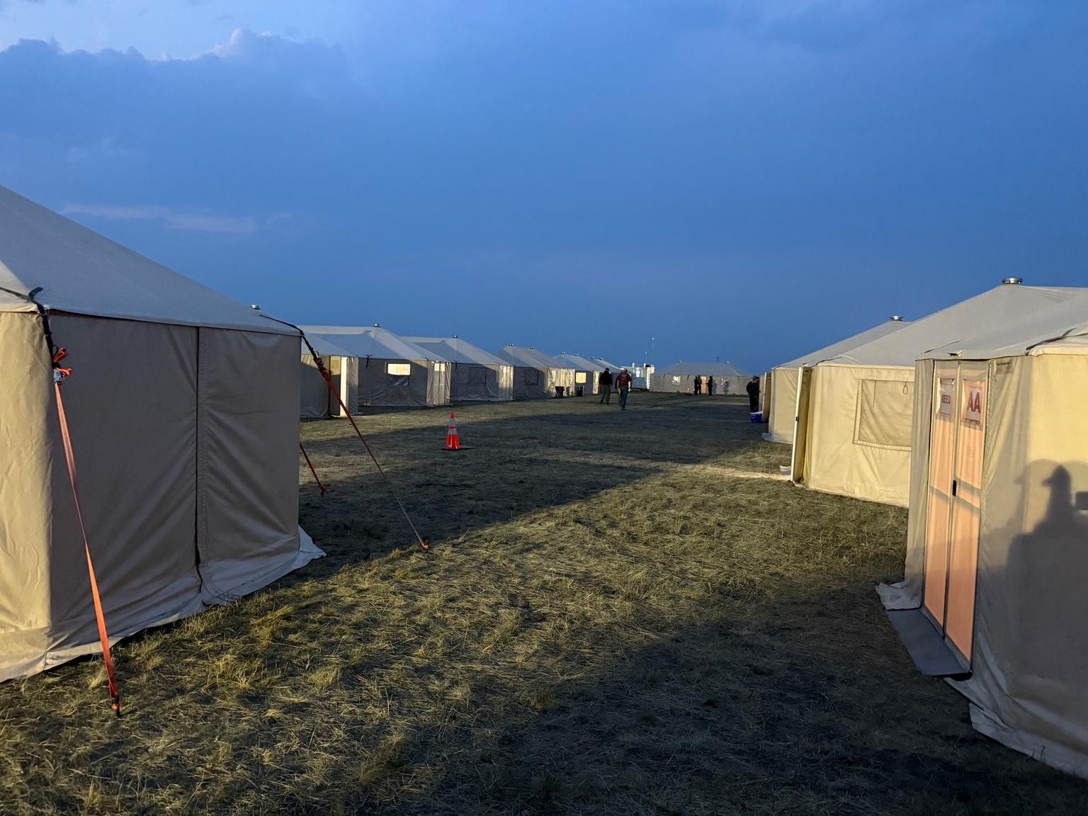 Rows of Intents field tents at dusk
