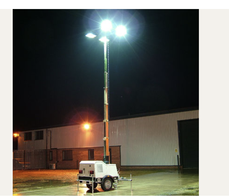 Portable light tower illuminating an outdoor work area at night
