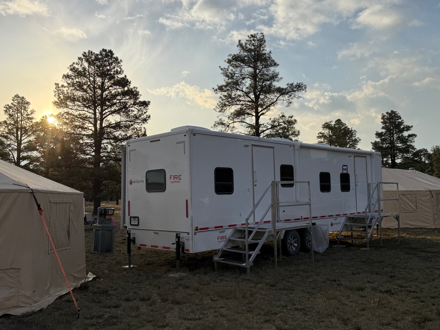 Intents office trailer between field tents at sunset